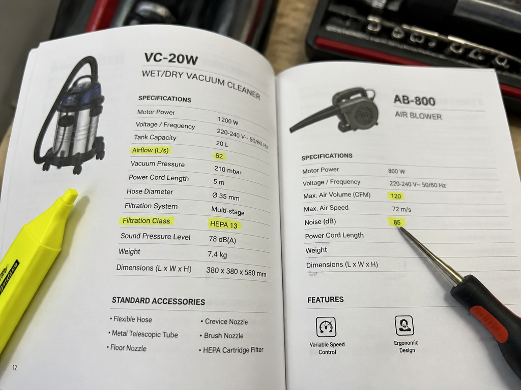 Close-up comparing vacuum and air blower technical specification sheets in a manual.